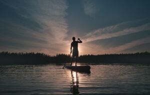 Person SUP boarding on a lake