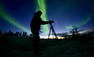 Man photographing Norhern Lights