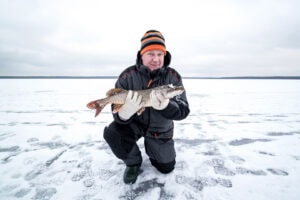 Man with a fish in winter