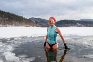 Woman standing in ice hole